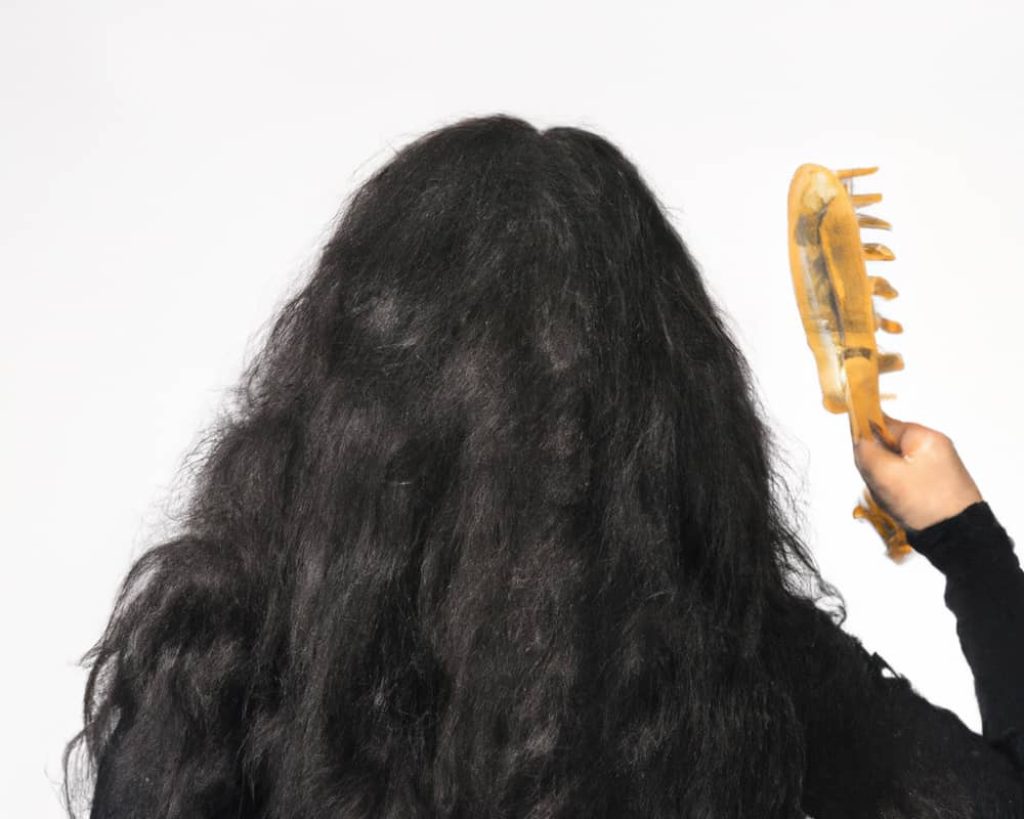 Is it acceptable for an Orthodox Jewish woman to use a boar bristle brush?

